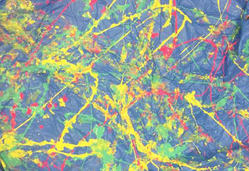 Splashed yellow, gree, and red paint on a blue background.